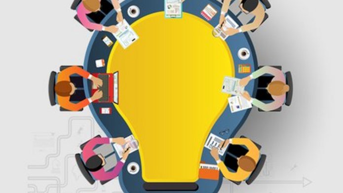 grafika IPMA XV, ludzie siedzący przy stole w kształcie żarówki